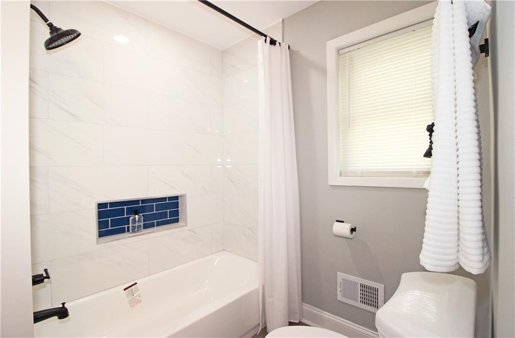 2450 Elkhorn Drive Decatur, GA 30034 - Photo 19 of 32 a bathroom with a shower a toilet and a window