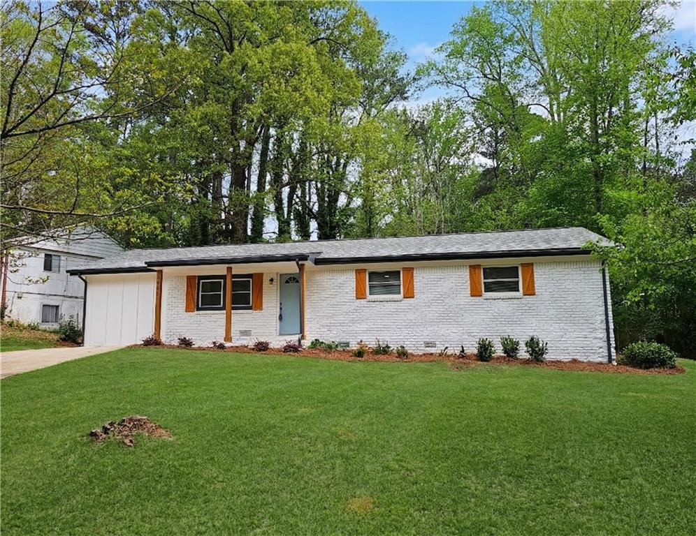 2450 Elkhorn Drive Decatur, GA 30034 - Photo 2 of 32 a front view of a house with a garden and yard