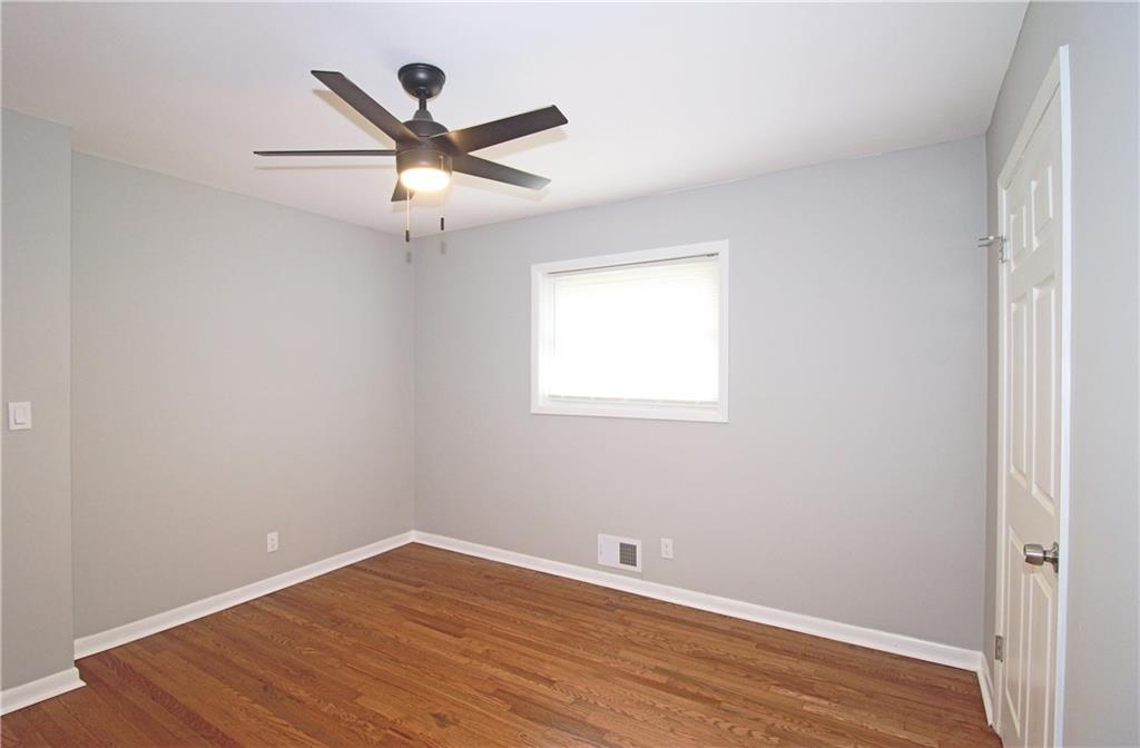 2450 Elkhorn Drive Decatur, GA 30034 - Photo 21 of 32 an empty room with wooden floor ceiling fan and window