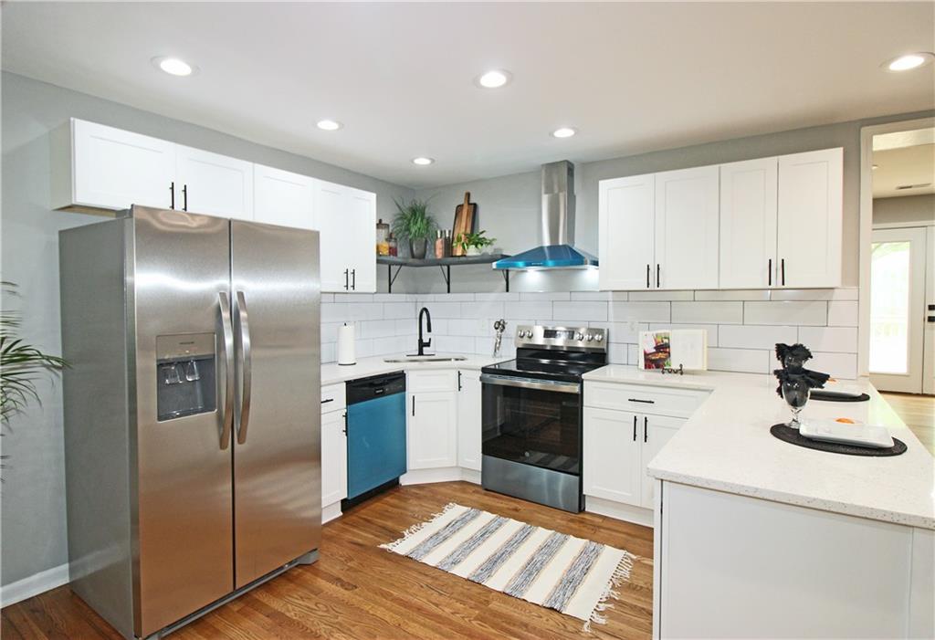 2450 Elkhorn Drive Decatur, GA 30034 - Photo 9 of 32 a kitchen with a sink stainless steel appliances and white cabinets
