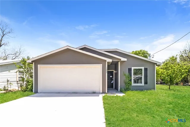 a front view of house with yard and green space