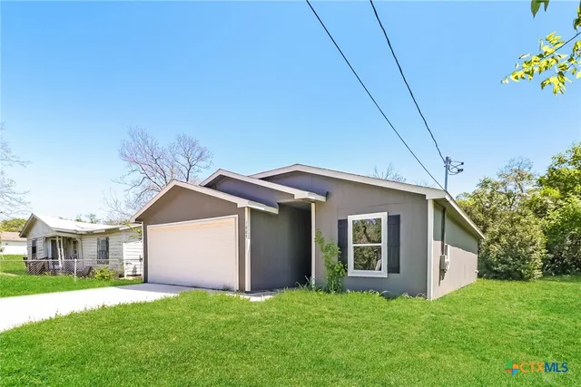 a big house with palm trees in the background