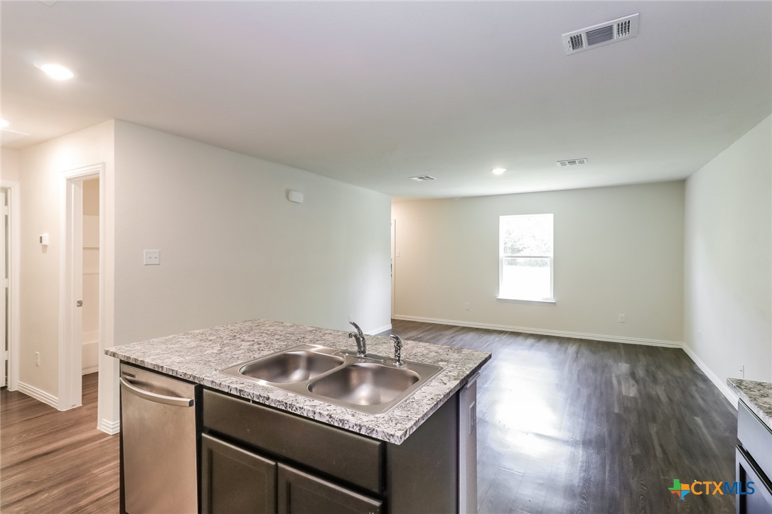 1005 South 22nd Street Temple, TX 76501 - Photo 8 of 21 a kitchen with granite countertop a sink and a stove