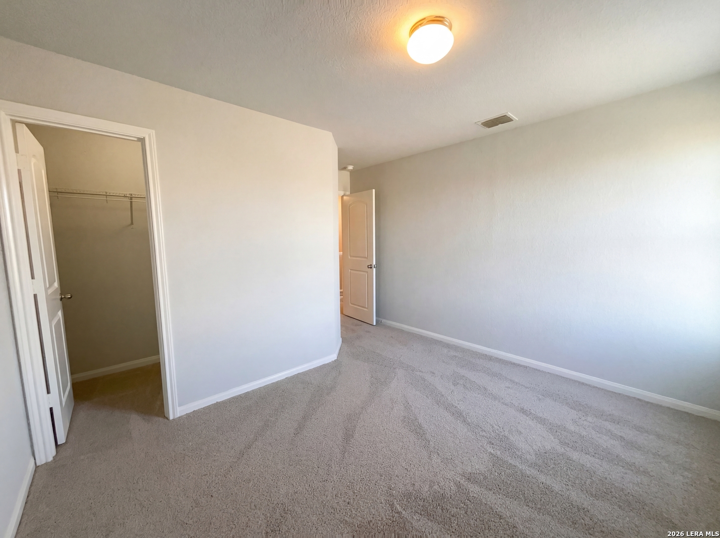 12325 Switchgrass San Antonio, TX 78252 - Photo 11 of 18 an empty room with closet and mirror