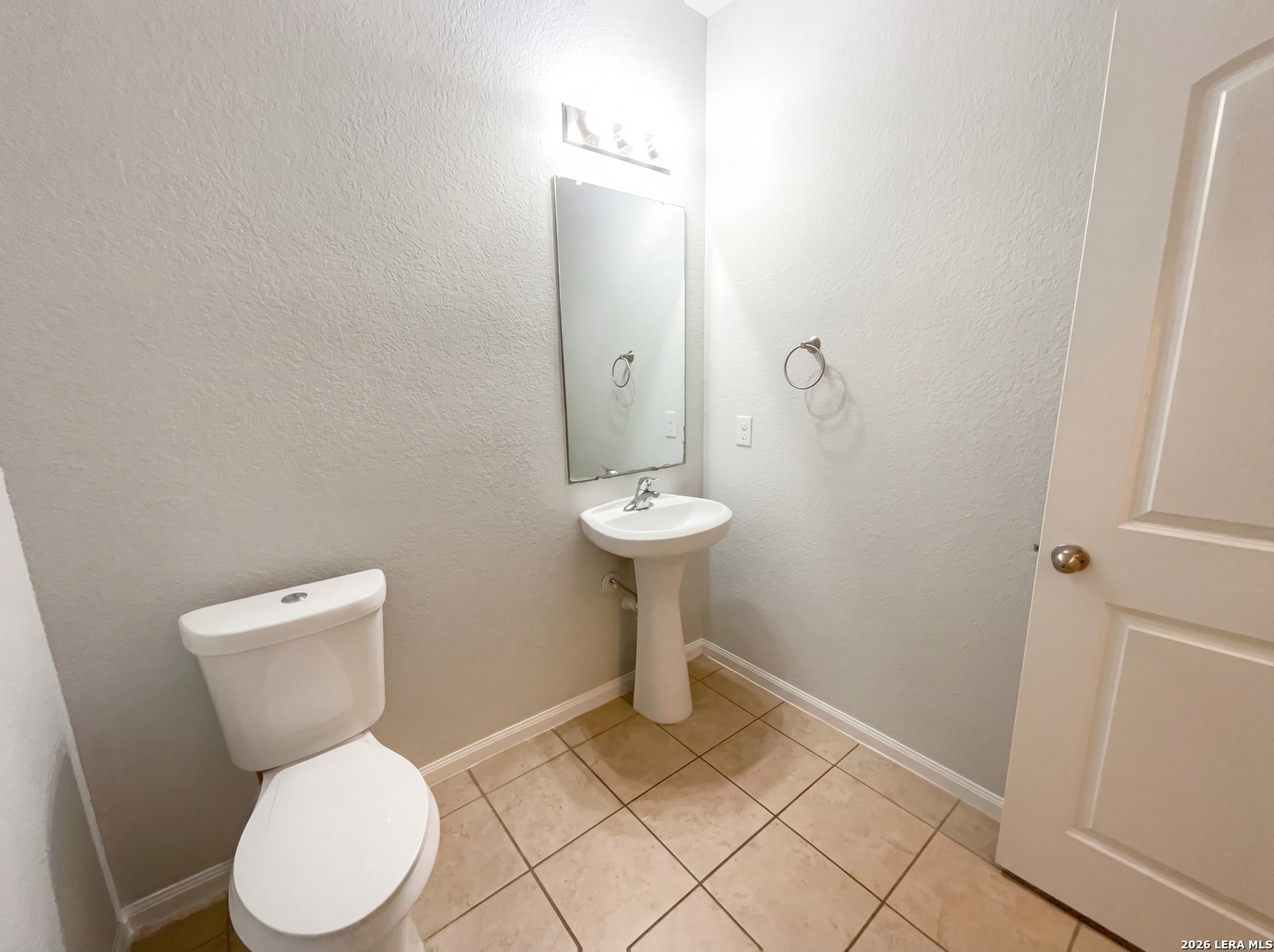 12325 Switchgrass San Antonio, TX 78252 - Photo 12 of 18 a bathroom with a toilet and a sink