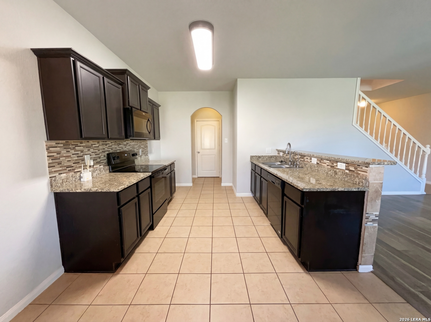 12325 Switchgrass San Antonio, TX 78252 - Photo 2 of 18 a kitchen with stainless steel appliances granite countertop a stove a sink and a refrigerator