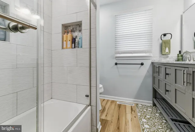 a bathroom with a tub sink and mirror
