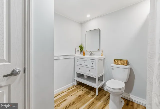 a bathroom with a toilet sink and mirror