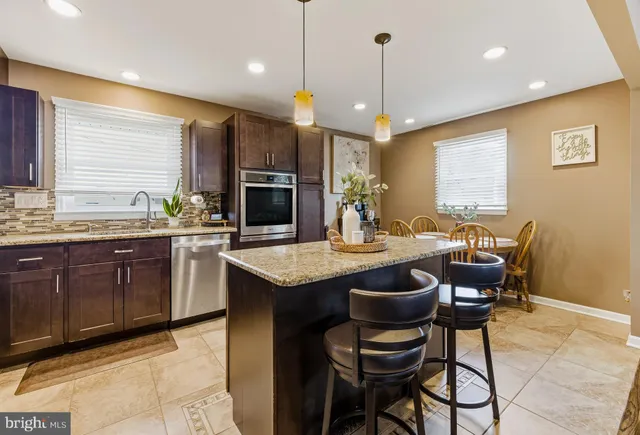 a kitchen with a table chairs sink and microwave