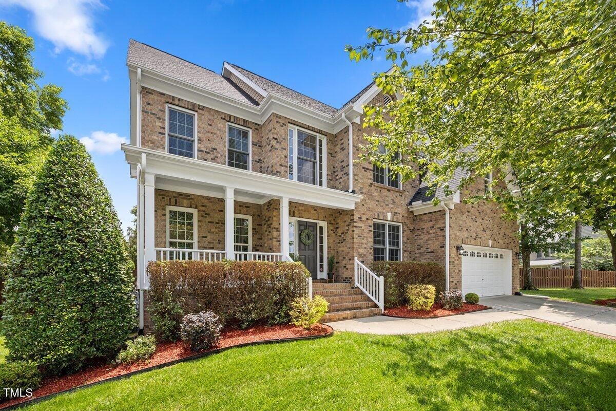 a view of a house with a yard and sitting area