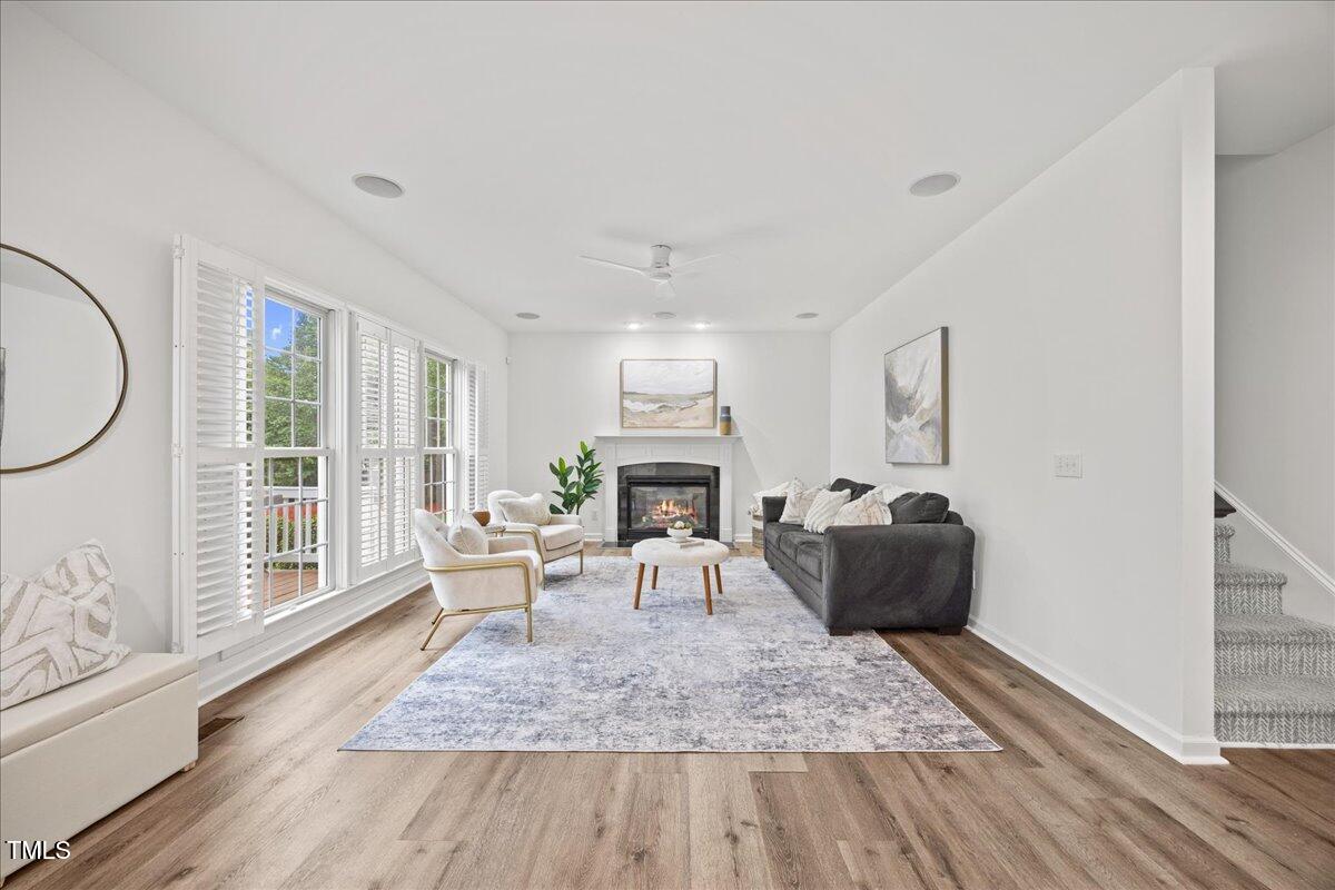 4 Pickard Place Durham, NC 27703 - Photo 15 of 80 a living room with furniture a fireplace and a large window with wooden floor