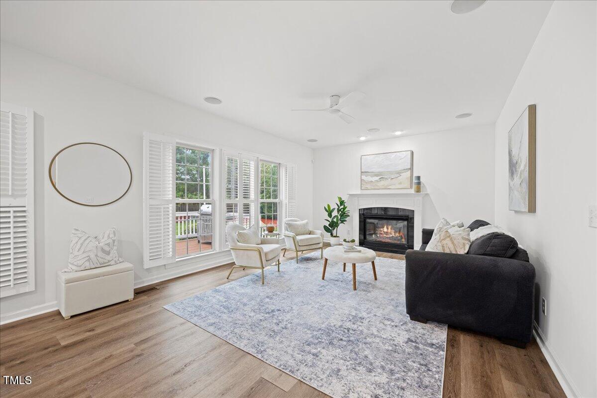4 Pickard Place Durham, NC 27703 - Photo 17 of 80 a living room with furniture a rug a fireplace and a large window