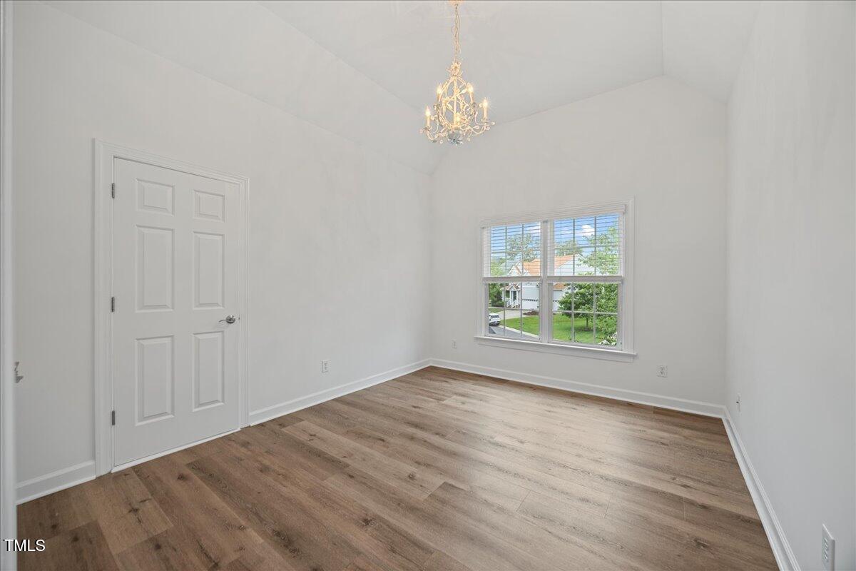 4 Pickard Place Durham, NC 27703 - Photo 31 of 80 a view of an empty room with wooden floor and a window