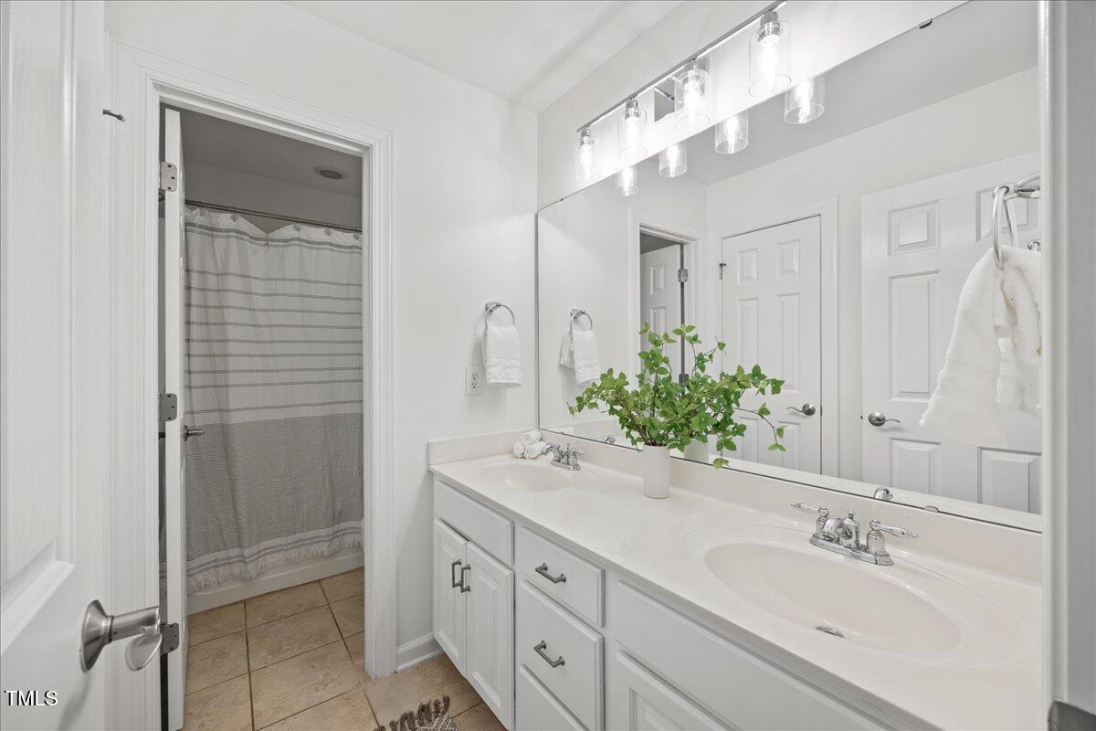 4 Pickard Place Durham, NC 27703 - Photo 34 of 80 a bathroom with a shower sink and mirror