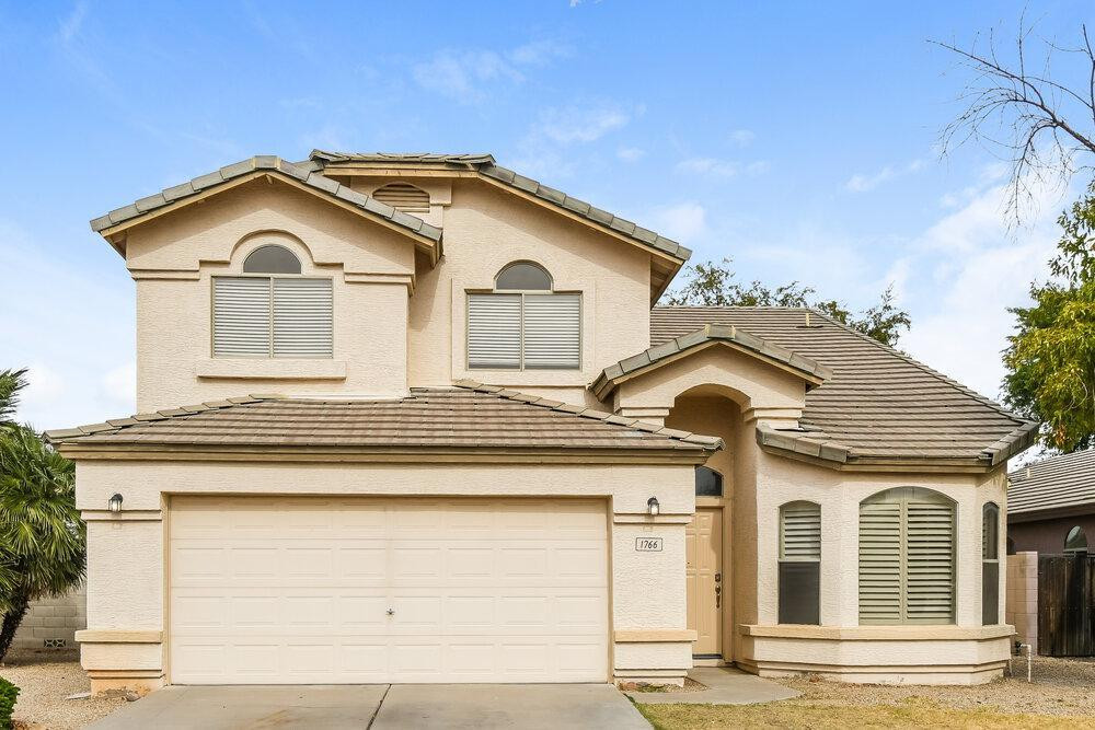 a front view of a house with garage