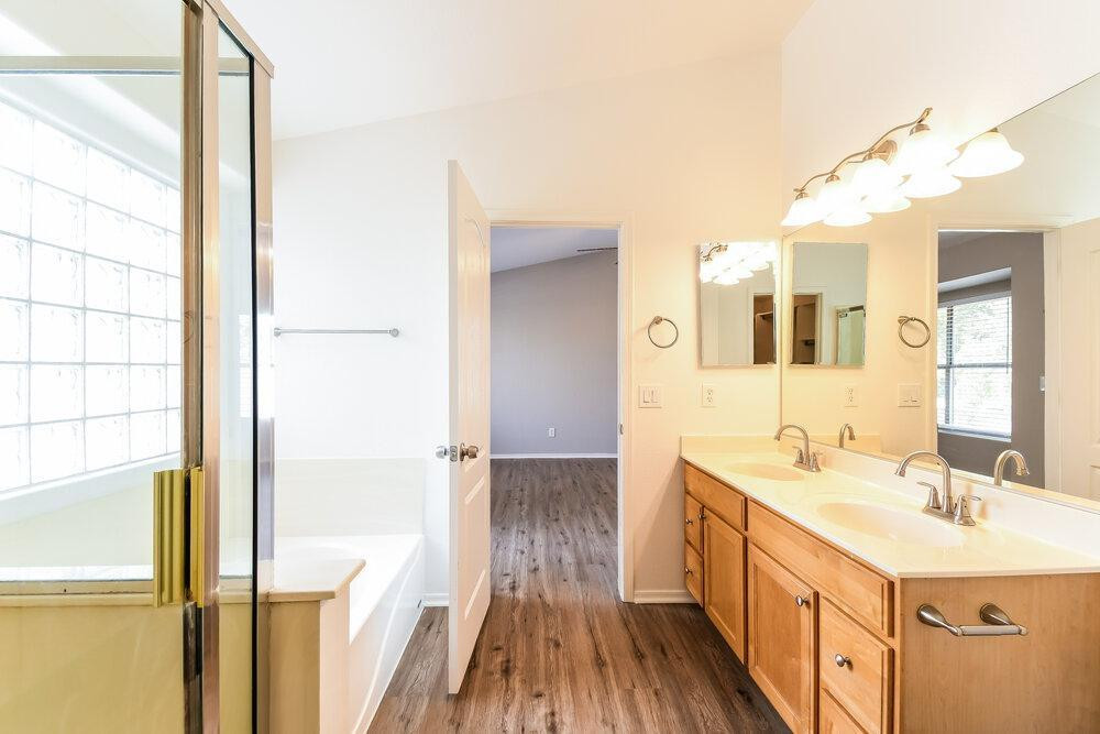 1766 East Tyson Street Gilbert, AZ 85295 - Photo 13 of 17 a bathroom with a sink a mirror and a shower