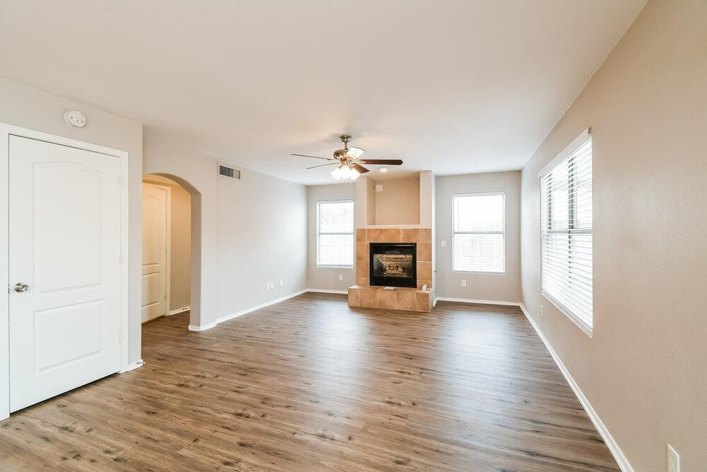 1766 East Tyson Street Gilbert, AZ 85295 - Photo 15 of 17 an empty room with wooden floor fireplace and windows