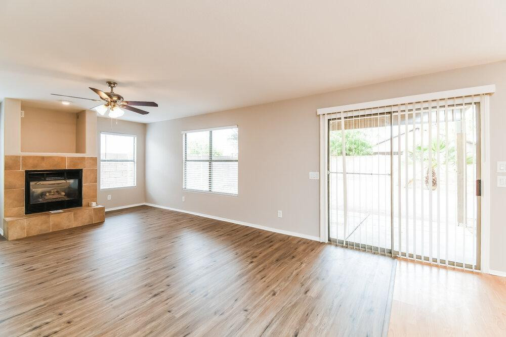 1766 East Tyson Street Gilbert, AZ 85295 - Photo 10 of 17 an empty room with wooden floor fireplace and windows