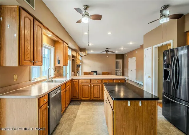 a kitchen with granite countertop a sink counter top space appliances and cabinets