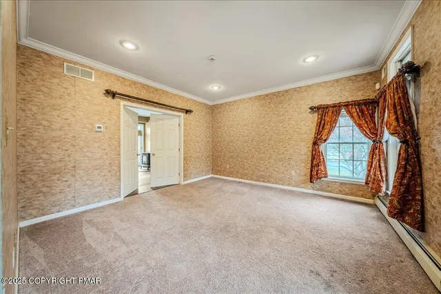 a view of a hallway with wooden shelves and a refrigerator