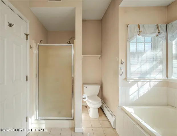 a view of staircase with lots of frames on wall and windows