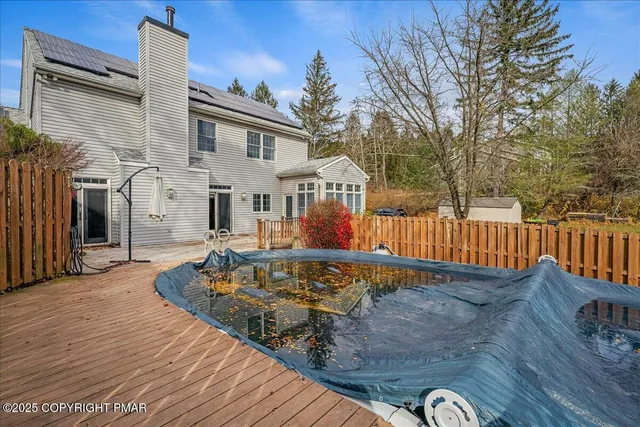 a swimming pool with trees in the background