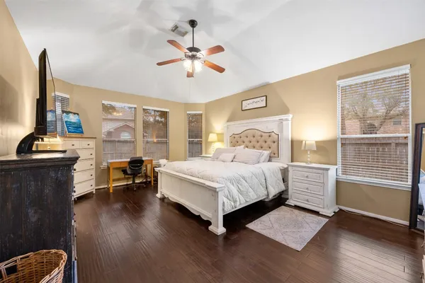 a bedroom with a bed and wooden floor