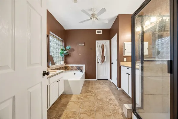 a spacious bathroom with a bathtub and a shower