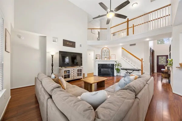 a living room with furniture a flat screen tv and a fireplace