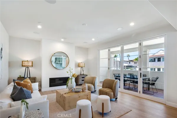 a living room with furniture a fireplace and a large window