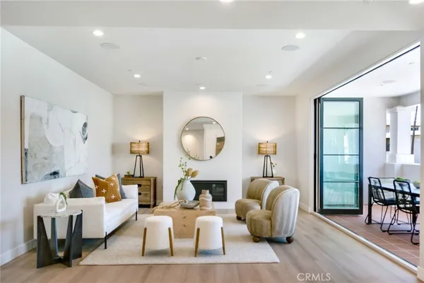 a living room with fireplace furniture and a large window