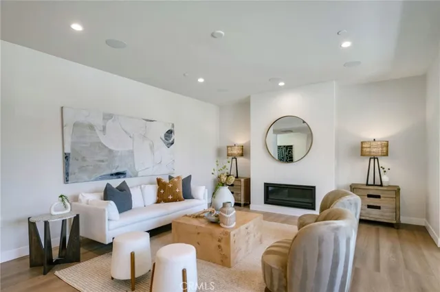 a living room with furniture a fireplace and a large window