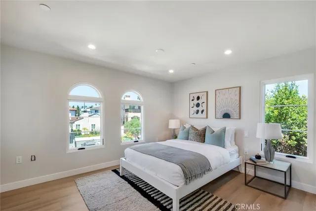 a bedroom with a large bed and a window