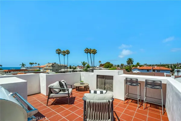 a view of roof deck with furniture