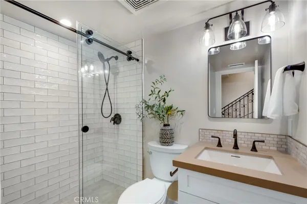 a bathroom with a sink toilet and shower