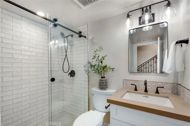 a bathroom with a sink toilet and shower