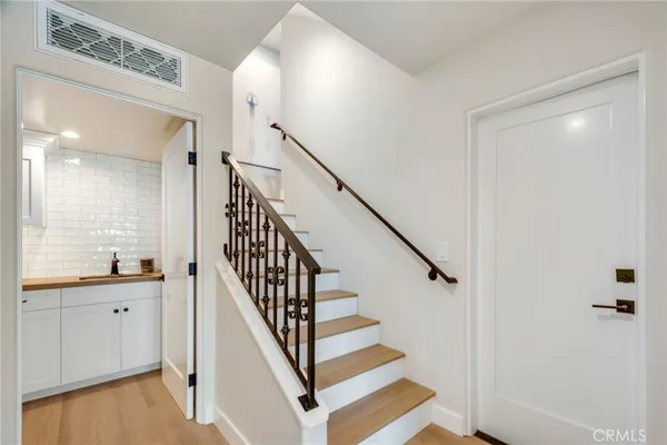 a view of entryway and hall with wooden floor