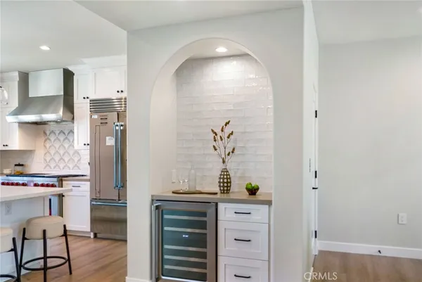 a kitchen with stainless steel appliances a refrigerator and cabinets