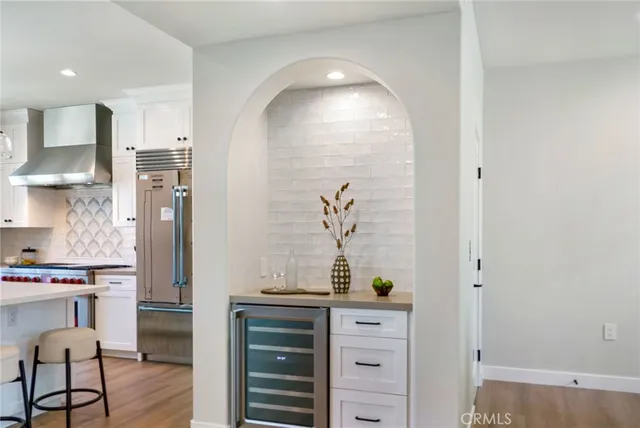 a kitchen with stainless steel appliances a refrigerator and cabinets