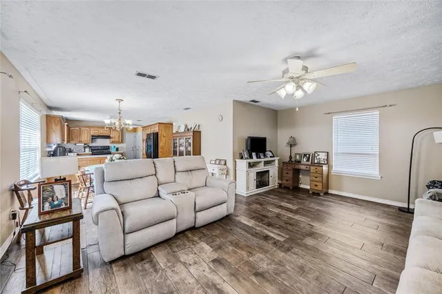 a living room with furniture and kitchen view