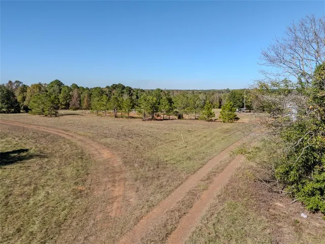 an aerial view of house with yard and ocean view