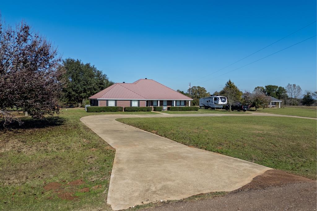 2895 County Road 118 Overton, TX 75684 - Photo 7 of 40 a view of a house with a yard
