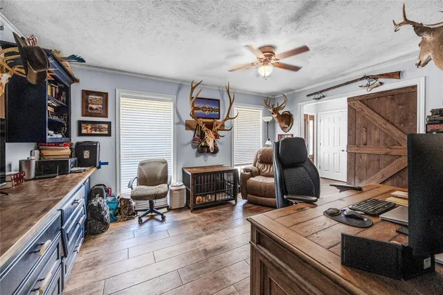 a work room with furniture and a flat screen tv