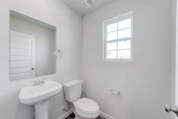 a bathroom with a sink a toilet and mirror