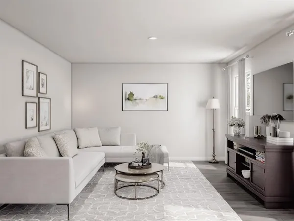 a living room with furniture a rug and a window