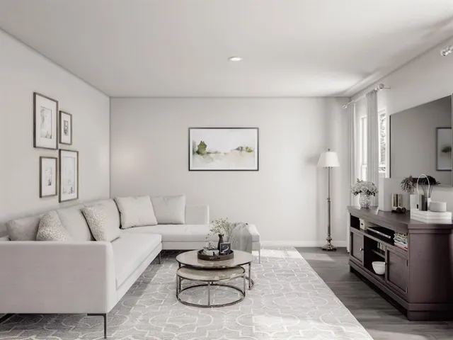 a living room with furniture a rug and a window