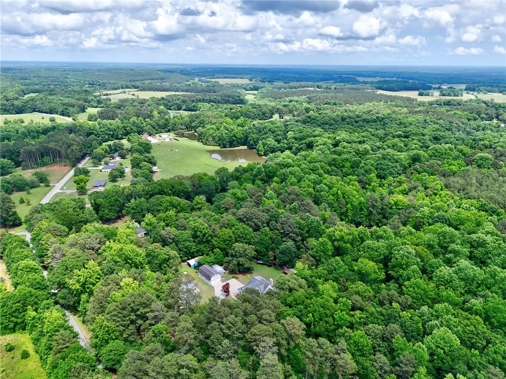 1016 Campbell Road Belton, SC 29627 - Photo 41 of 50 An aerial panorama reveals a verdant landscape with scattered homes and a serene pond.