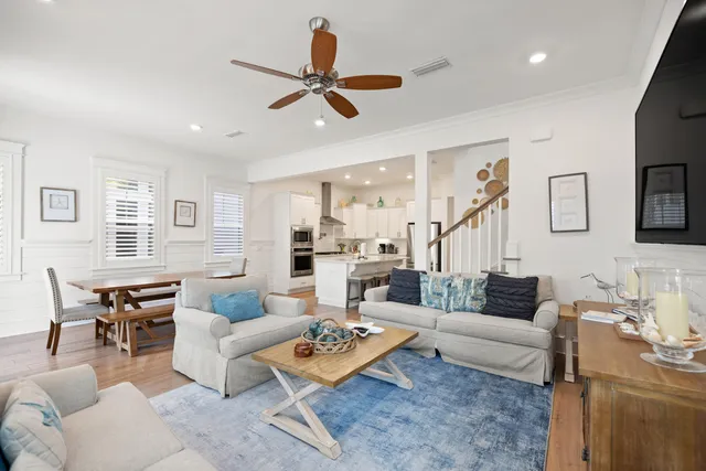 a bedroom with a bed a ceiling fan and a dresser