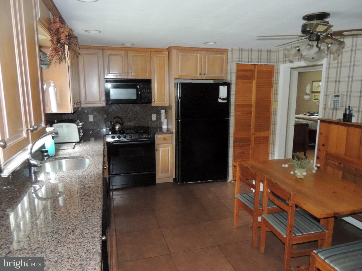 2380 Steven Road Huntingdon Valley, PA 19006 - Photo 7 of 24 a kitchen with stainless steel appliances granite countertop a refrigerator a stove a sink a dining table and chairs