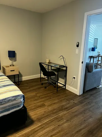 a room with furniture and a wooden floor